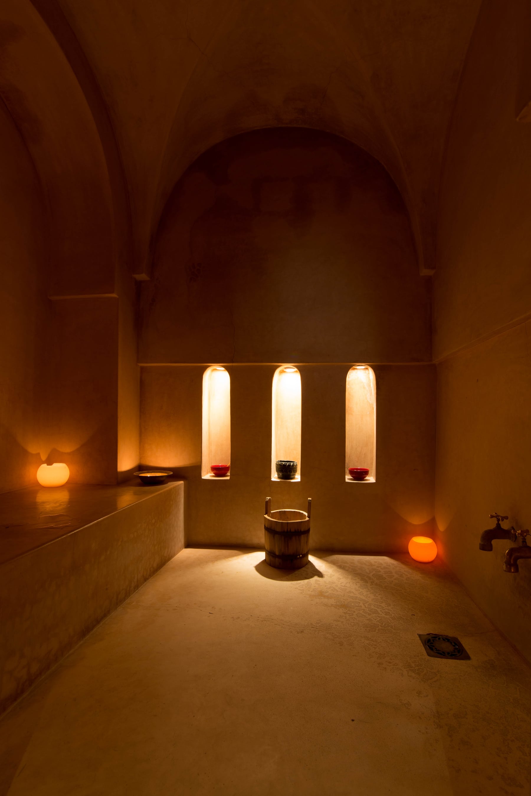 The candlelit tadelakt interior of Dar Akal's hammam